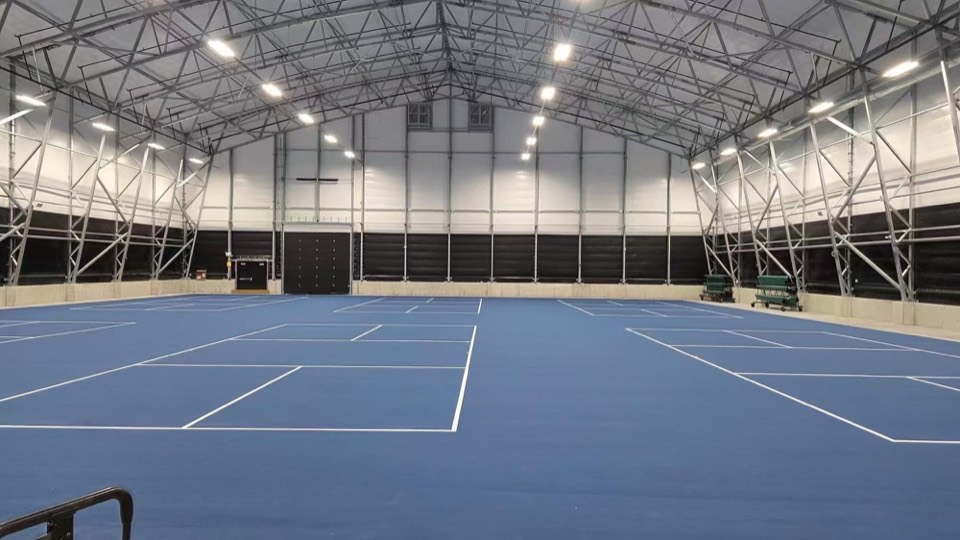 Indoor courts with textured acrylic sports surfacing and line striping