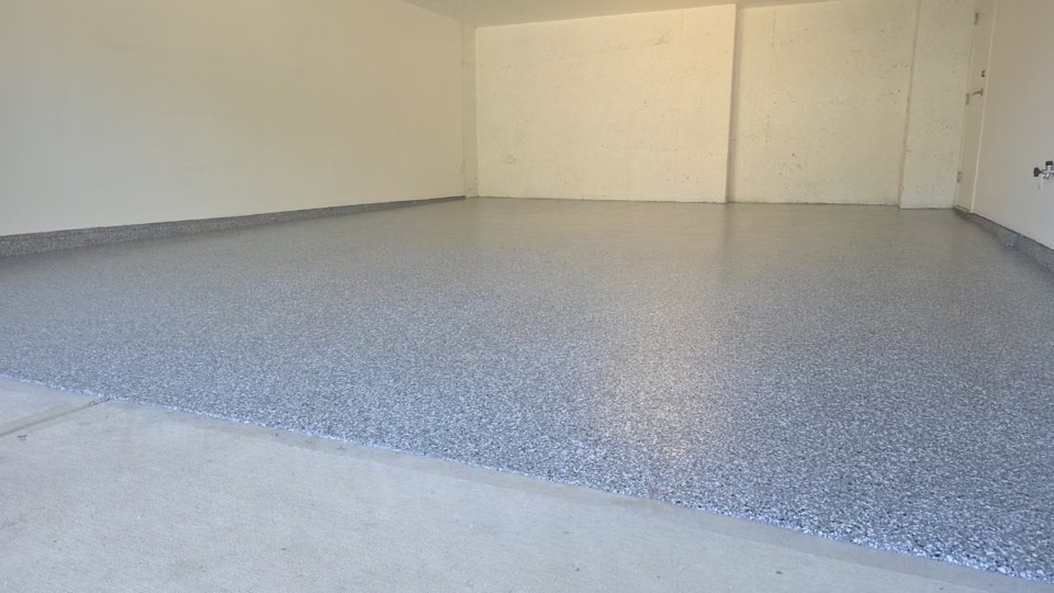 Residential garage floor finished in decorative flake epoxy with a clear polyaspartic topcoat — Deluxe Coating