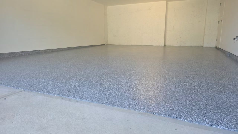 Residential garage floor finished in decorative flake epoxy with a clear polyaspartic topcoat — Deluxe Coating